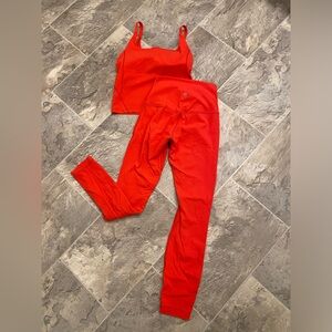 Bright red lululemon leggings and crop top.